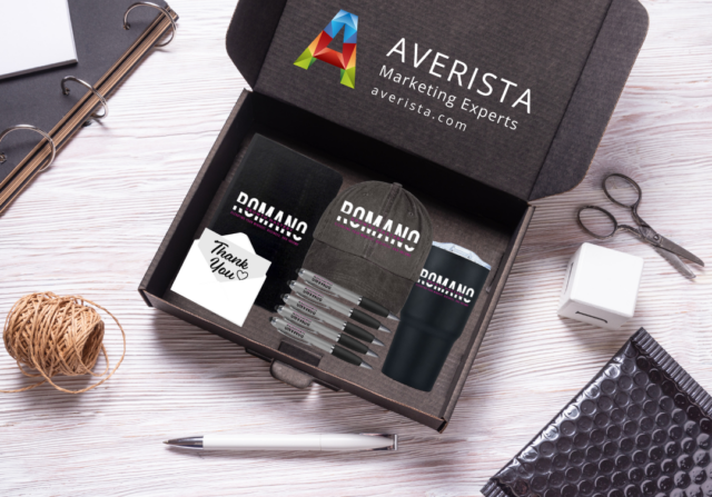 A branded box containing a notebook, pens, and a tumbler, representing building a brand through personalized client experiences.